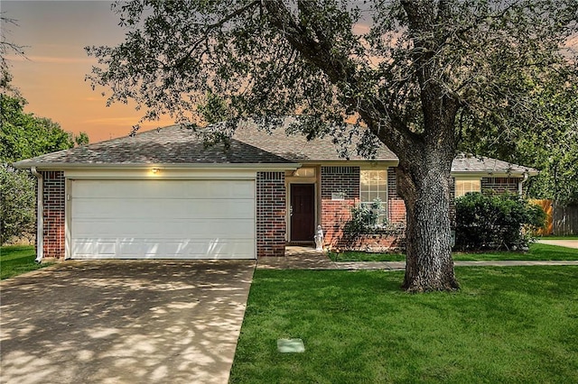 713 Broadmoor Dr, Bryan, TX 77802 - ranch-style home featuring brick siding, concrete driveway, a garage, and a yard