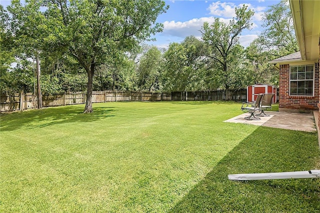 713 Broadmoor Dr, Bryan, TX 77802 - view of yard featuring a storage unit, a patio, an outdoor structure, and view of wooded area