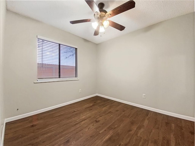 spare room with ceiling fan and dark hardwood / wood-style flooring