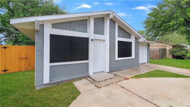 view of outbuilding with a yard