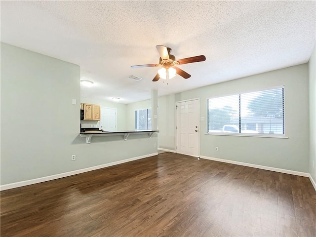 spare room featuring a textured ceiling, ceiling fan, and dark hardwood / wood-style floors