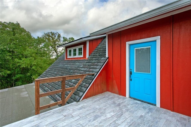 view of exterior entry with a deck