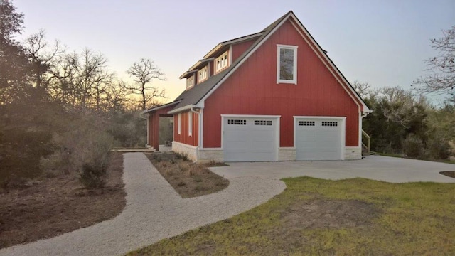 view of garage at dusk