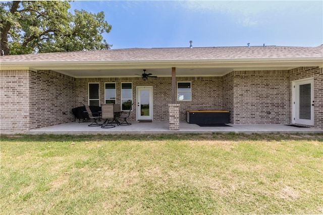 10146 Henley Cv, Iola, TX 77861 - rear view of property with a ceiling fan, a patio, a lawn, and brick siding