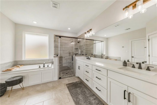 10146 Henley Cv, Iola, TX 77861 - full bath featuring a stall shower, double vanity, a bath, and tile patterned floors