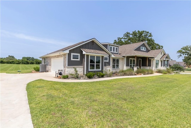 10146 Henley Cv, Iola, TX 77861 - craftsman house featuring stone siding, board and batten siding, a front yard, and driveway