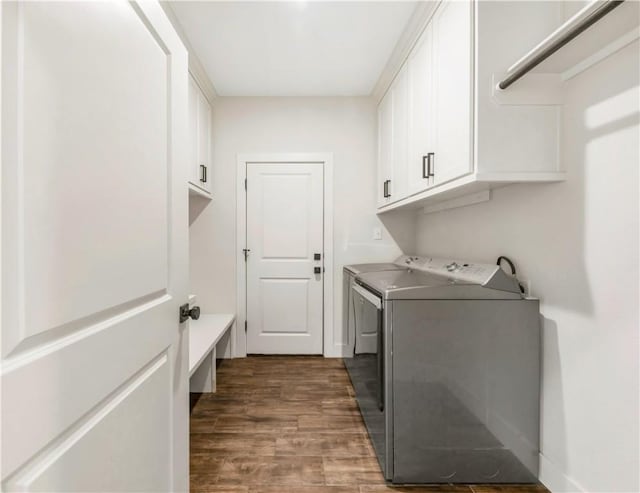 10146 Henley Cv, Iola, TX 77861 - washroom with cabinet space, independent washer and dryer, and dark wood finished floors