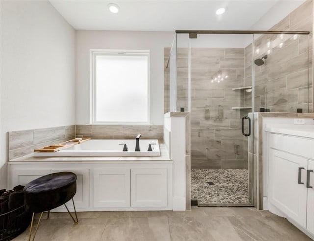 10146 Henley Cv, Iola, TX 77861 - bathroom featuring a bath, a shower stall, recessed lighting, and vanity