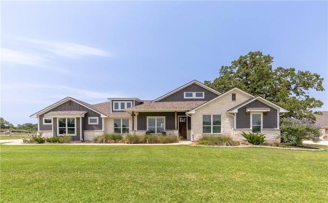 10146 Henley Cv, Iola, TX 77861 - craftsman-style home featuring stone siding, board and batten siding, and a front lawn