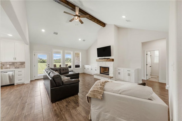 10146 Henley Cv, Iola, TX 77861 - living area featuring beam ceiling, a stone fireplace, high vaulted ceiling, a ceiling fan, and light wood finished floors