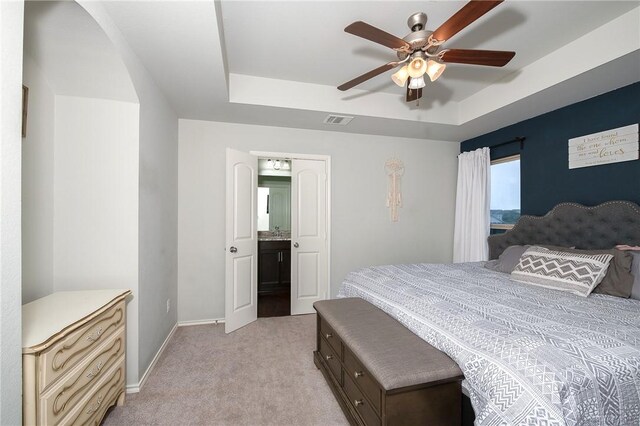 122 Dove Ct, Navasota, TX 77868 - bedroom featuring a raised ceiling, light carpet, and ceiling fan