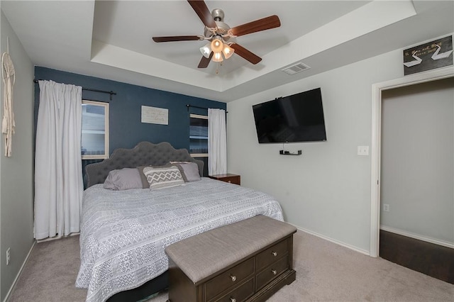 122 Dove Ct, Navasota, TX 77868 - carpeted bedroom featuring a raised ceiling and a ceiling fan