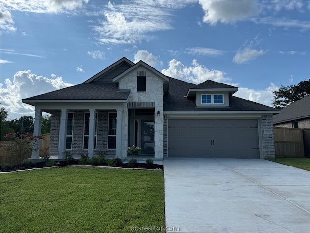 view of front of home with a garage and a front lawn