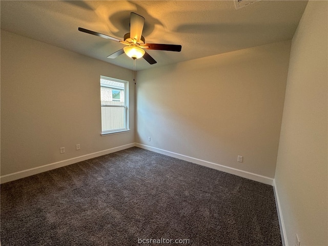 spare room with dark carpet and ceiling fan