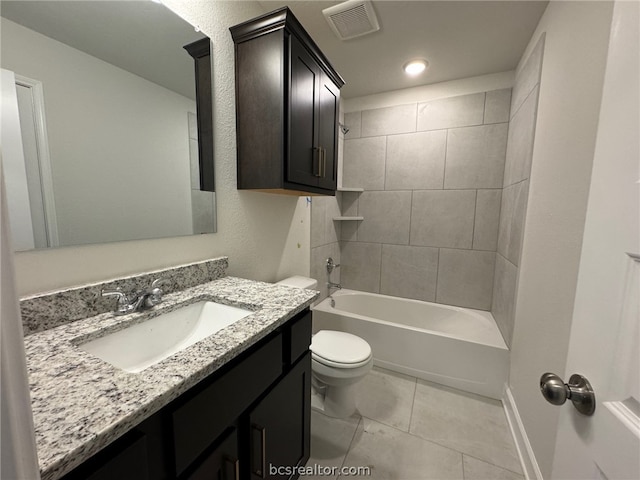 full bathroom featuring tile patterned flooring, tiled shower / bath combo, toilet, and vanity