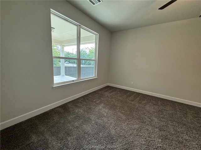 carpeted spare room with ceiling fan