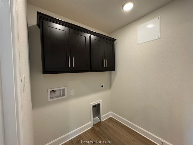 clothes washing area with hookup for a washing machine, dark hardwood / wood-style flooring, cabinets, and hookup for an electric dryer