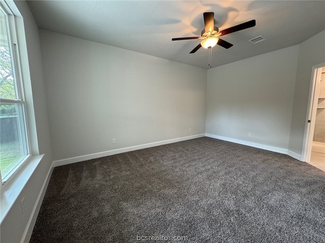 carpeted spare room with ceiling fan and a healthy amount of sunlight