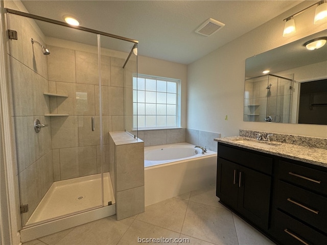 bathroom with shower with separate bathtub, vanity, and tile patterned floors