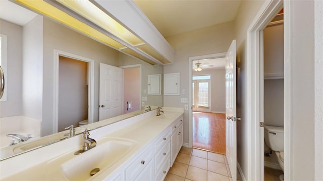 bathroom featuring double vanity, tile patterned flooring, a sink, and toilet