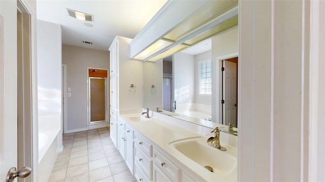 full bath featuring a garden tub, a sink, and visible vents