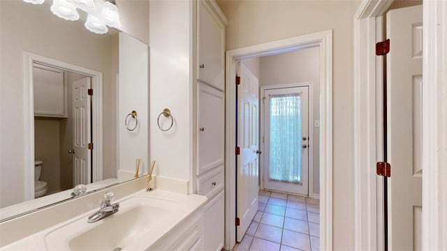 bathroom with vanity, tile patterned flooring, and toilet