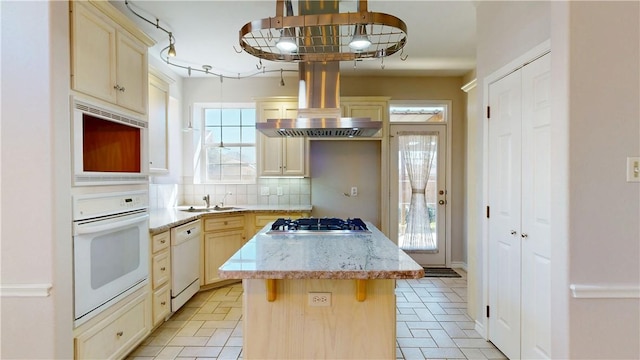 kitchen with white appliances, decorative backsplash, a kitchen island, island exhaust hood, and a kitchen bar