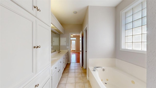 full bathroom featuring tile patterned floors, a jetted tub, and double vanity