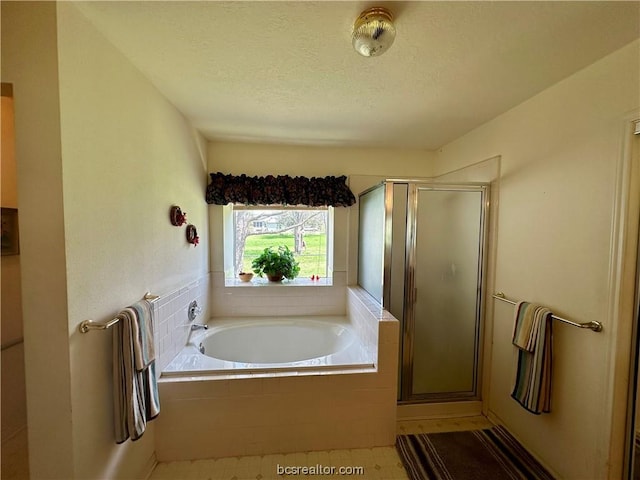 bathroom featuring tile patterned floors, shower with separate bathtub, and a textured ceiling