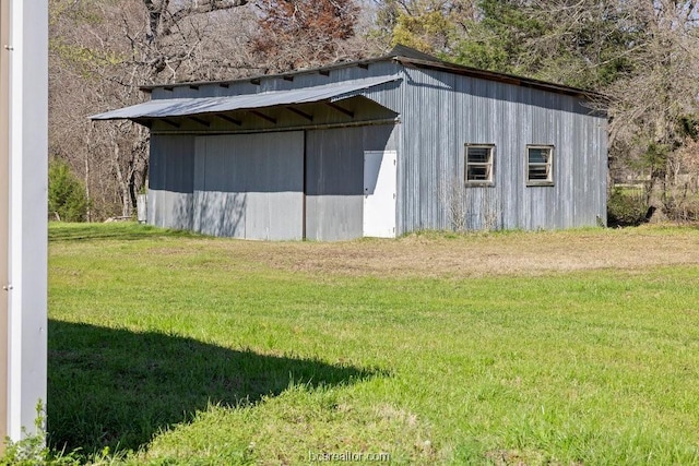 view of outbuilding with a lawn