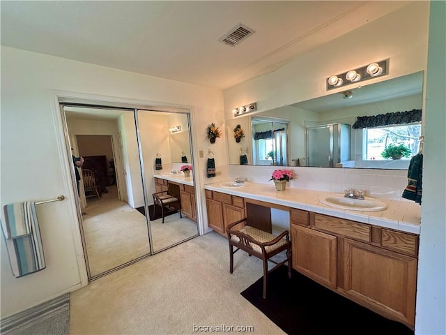 bathroom with vanity and walk in shower