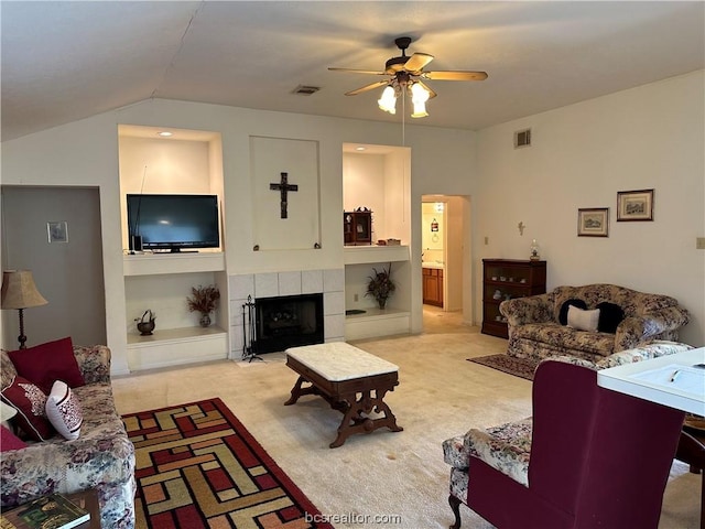 living room with light carpet, lofted ceiling, ceiling fan, and a fireplace