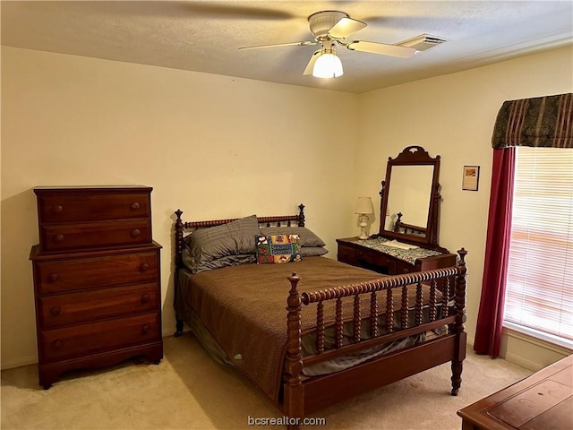 bedroom featuring light carpet and ceiling fan