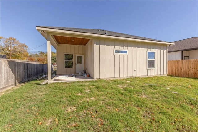 back of property featuring a patio area and a lawn