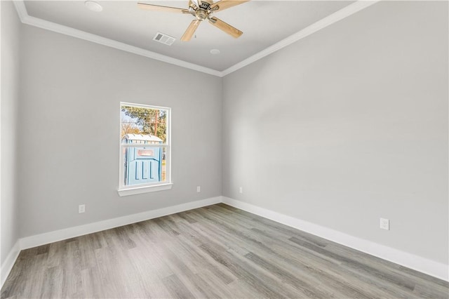 spare room with light hardwood / wood-style flooring, ceiling fan, and ornamental molding