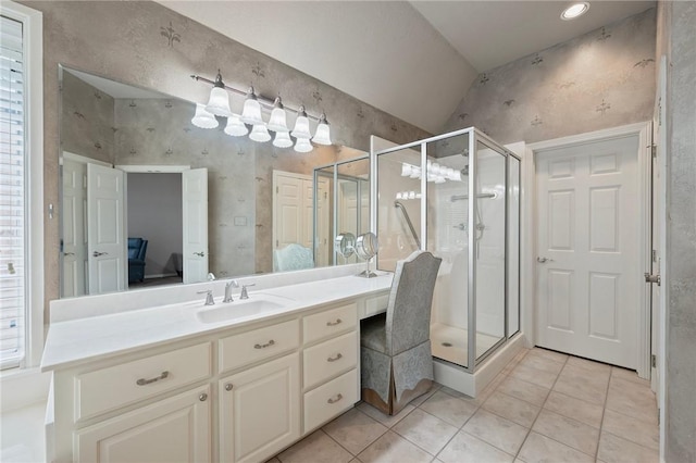 bathroom with tile patterned flooring, lofted ceiling, a stall shower, and vanity