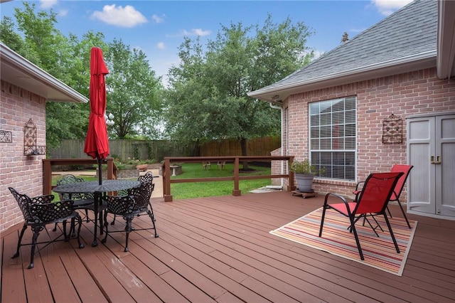 deck with outdoor dining area and a fenced backyard