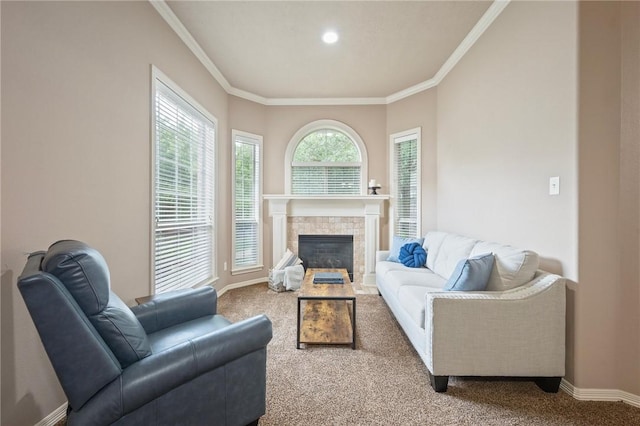 carpeted living area with crown molding, baseboards, and a tiled fireplace