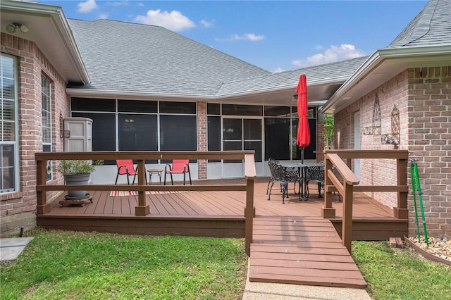 deck with outdoor dining area and a sunroom