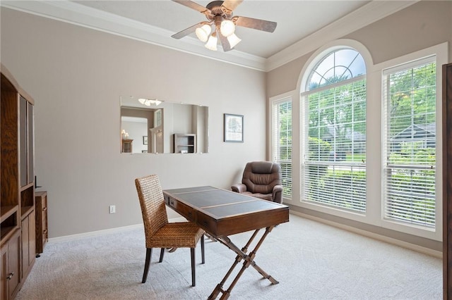 home office featuring light colored carpet, ornamental molding, baseboards, and ceiling fan
