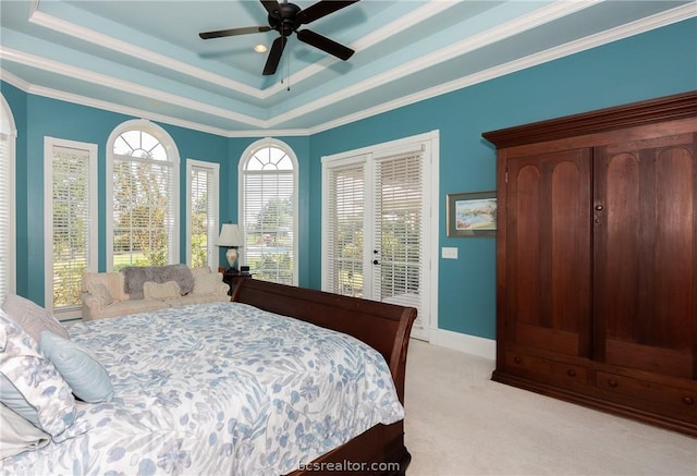 bedroom featuring access to outside, crown molding, ceiling fan, a tray ceiling, and light colored carpet