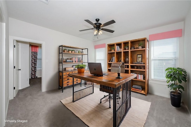 carpeted home office with ceiling fan