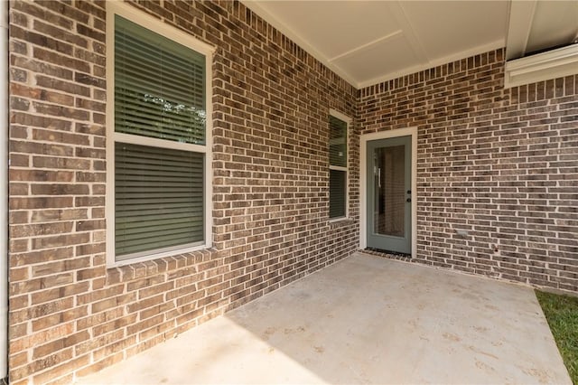 view of exterior entry featuring a patio