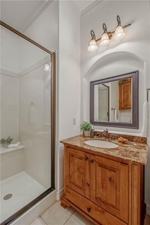 3281 Toltec Trl, College Station, TX 77845 - bathroom with crown molding, vanity, tile patterned flooring, and a stall shower