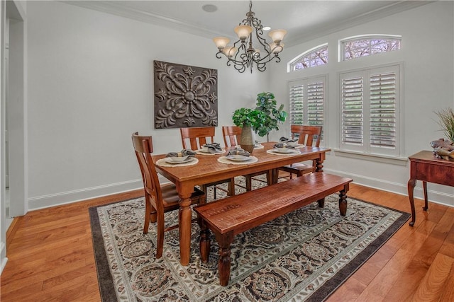 3281 Toltec Trl, College Station, TX 77845 - dining space featuring baseboards, ornamental molding, light wood finished floors, and a chandelier