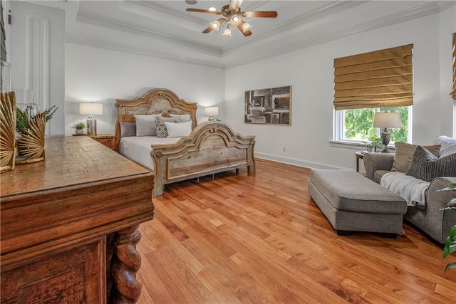 3281 Toltec Trl, College Station, TX 77845 - bedroom featuring ceiling fan, crown molding, light wood-type flooring, a raised ceiling, and baseboards