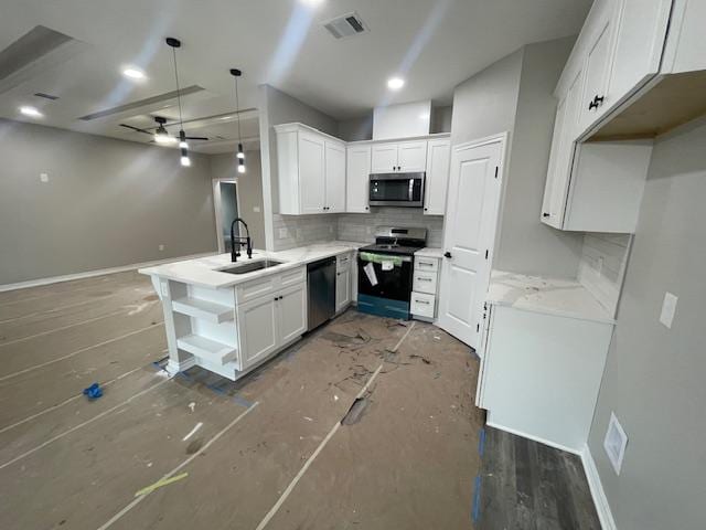 kitchen with white cabinetry, sink, kitchen peninsula, and appliances with stainless steel finishes