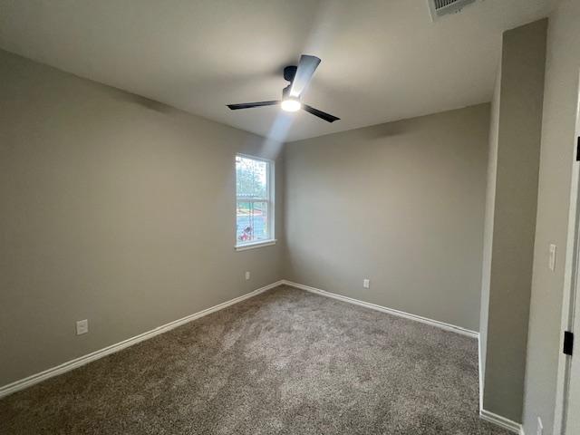 spare room featuring ceiling fan and carpet floors