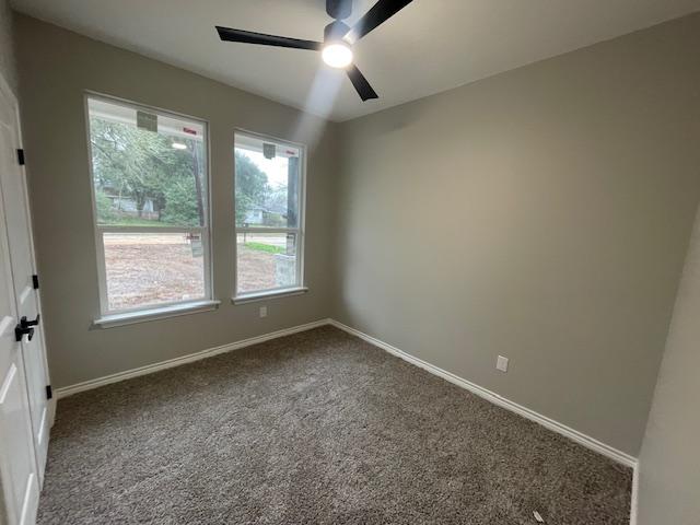 carpeted empty room with ceiling fan