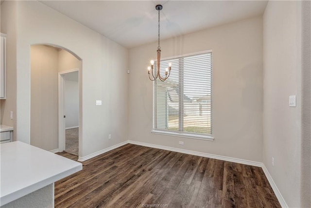 3429 Alsace Ct, Bryan, TX 77808 - unfurnished dining area with arched walkways, dark wood-style flooring, and a chandelier